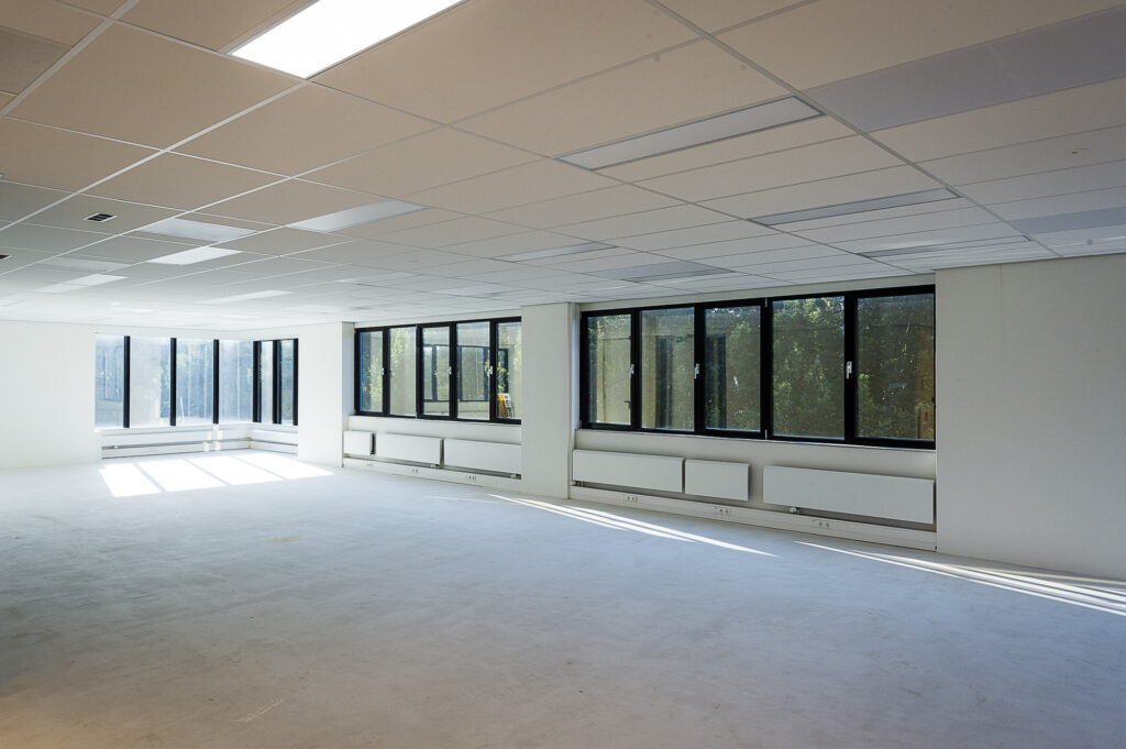 Lichte, lege kantoorruimte aan de Max Euwelaan met grote ramen en systeemplafond.